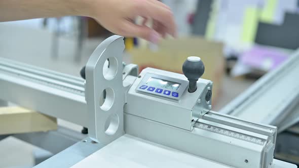 The man sets up the marking on the electronic board of the circular saw