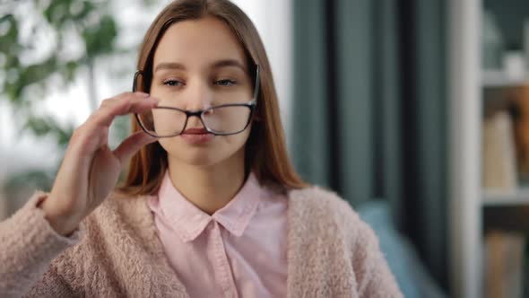 Tired Woman Rubbing Her Eyes on Couch