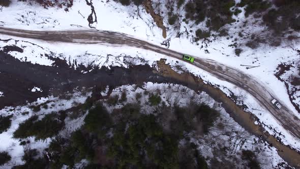 Drone top view SUV driving on a mountain road. winter.