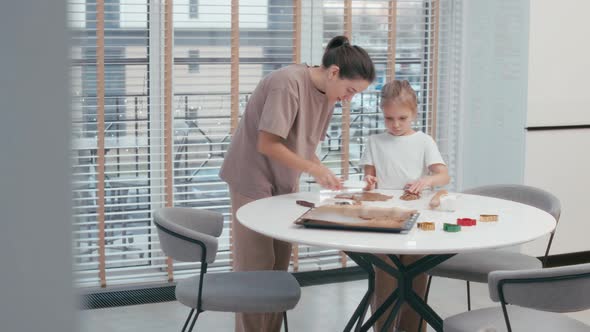 Mother with daughter baking cookies