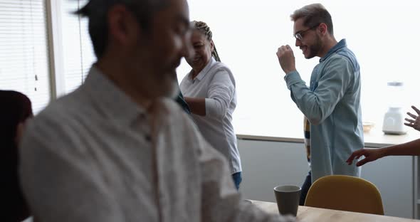 Multiracial friends having fun dancing at home kitchen