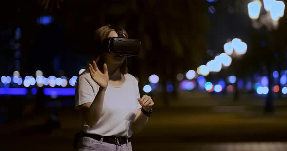 Young Girl in Virtual Reality Glasses in a Big Metropolis