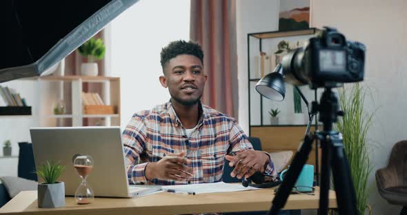 Man Sitting in front of Camera at Home and Recording New Videovlog for His Followers