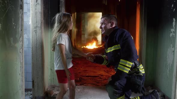 Fireman Interrogating Girl in Burning Hallway