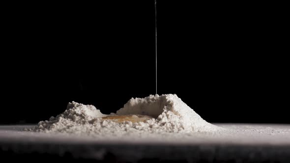 The Egg Falls in Slow Motion Into Flour alt