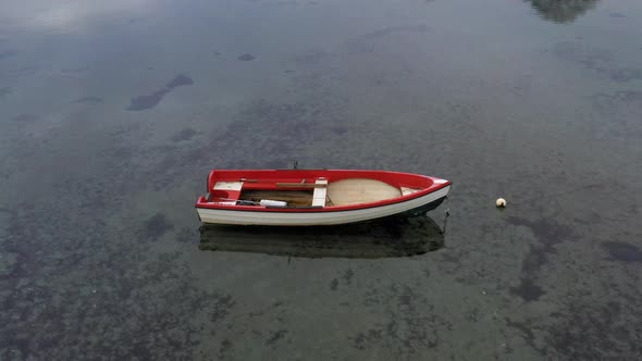 Rowboat with Red and White Color Floating