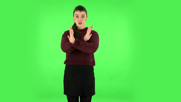 Woman Strictly Gesturing with Hands Crossed Making X Shape Meaning Denial Saying NO. Green Screen