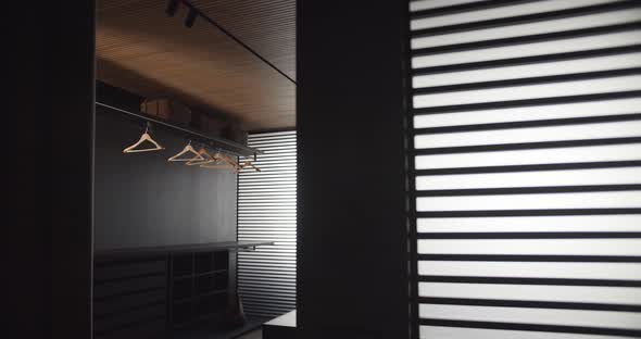 Black Minimalist Style Clothing Room with Large Sliding Doors and Windows