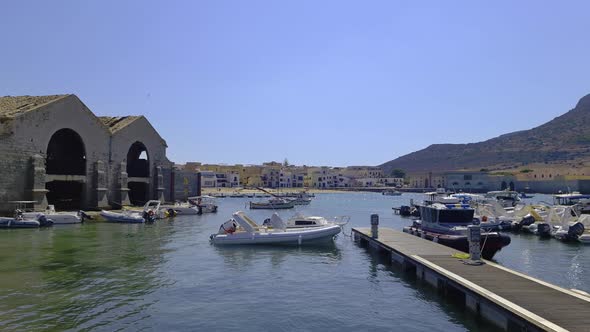 Famous Florio tuna factory or tonnara at port of Favignana and Santa Caterina castle on top of mount