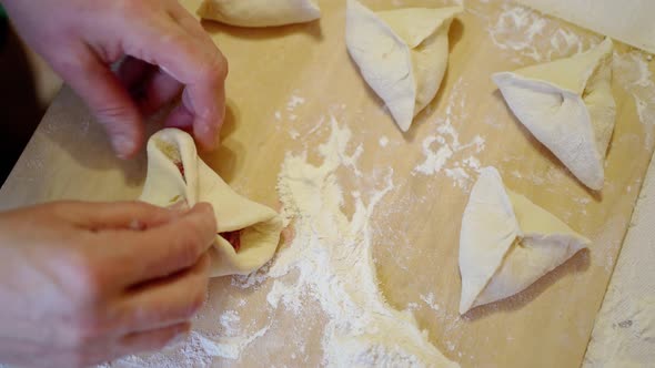 Female Hands Mold Meat Pies