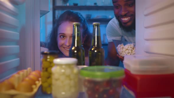 Happy Couple Taking Beer Bottles From Refrigerator