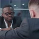 Pensive Afro-american and Caucasian Businessmen Working Through Papers and Discussing Financial - VideoHive Item for Sale