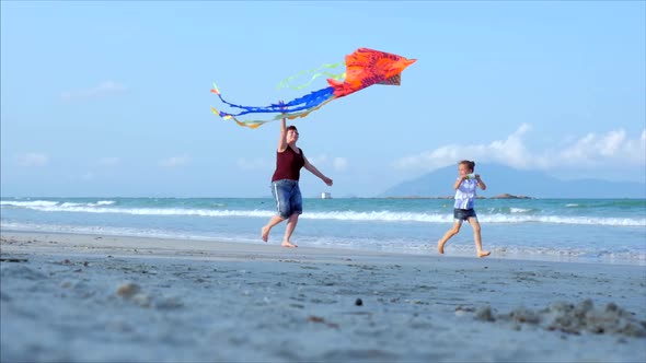 Happy Grandmother with Child the Playing Flying Kite, the Family Runs on the Sand