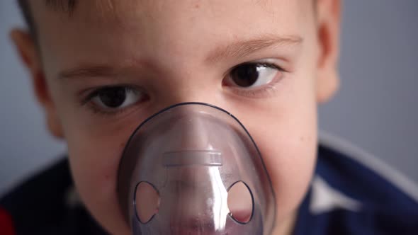 Close-up child breathing with a nebulizer