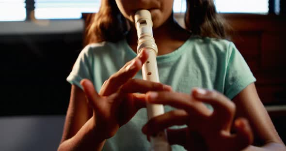 Schoolgirl playing flute in music class 4k