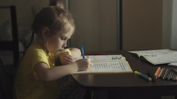 Preschool girl doing homework at home