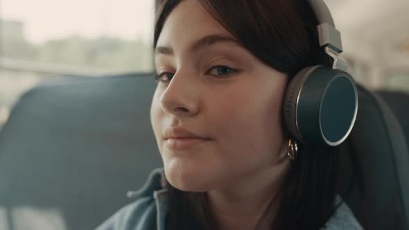 Dreamy Girl Face Listening Music with Headphones Closeup