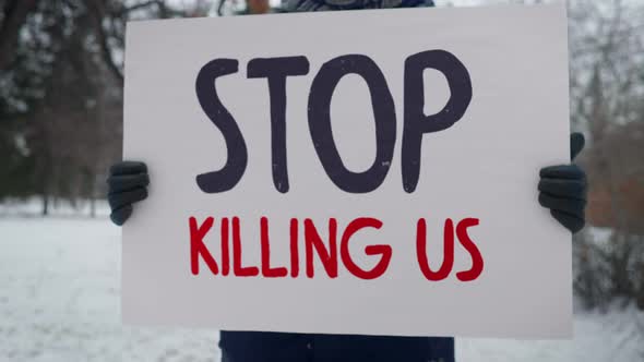 Placard Stop Killing Us Calls Police To End Violent Racial Discrimination