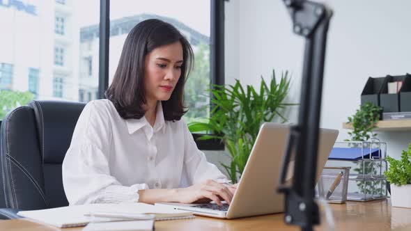 Asian young businesswoman working on a computer in the office with a new normal lifestyle