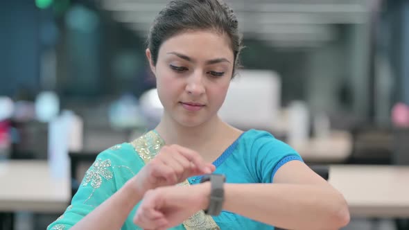 Young Indian Woman using Smart Watch