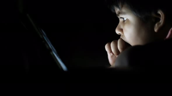 Child Girl Using Digital Tablet at Night,