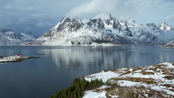 Hyperlapse of the snow capped Austnesfjorden Mountains of Lofoten with clouds streaming over the top