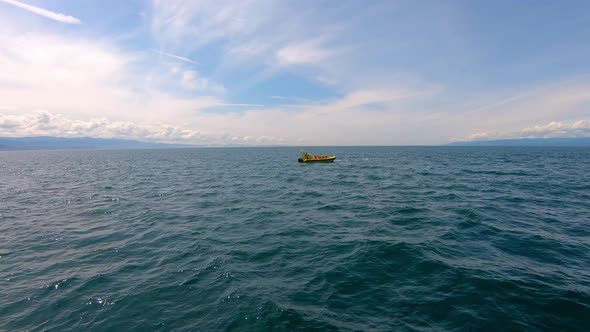 View Of Lone Boat In Middle Of Ocean. Slow Motion