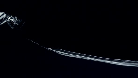 Slo-motion water against black drop alt