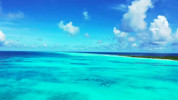 Wide above clean view of a white sand paradise beach and aqua blue ocean background in hi res 4K