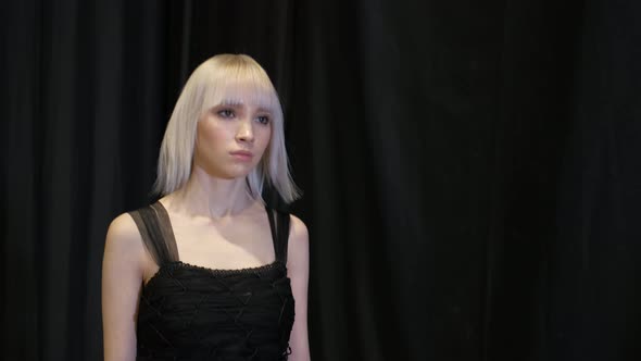 Albino Model Walks on Runway Podium