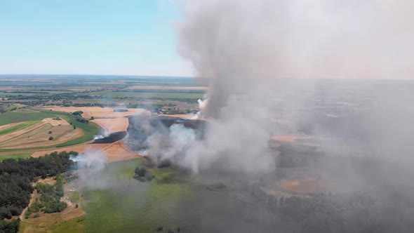 Aerial View of Fire in Wheat Field. Flying Over Smoke Above Agricultural Fields