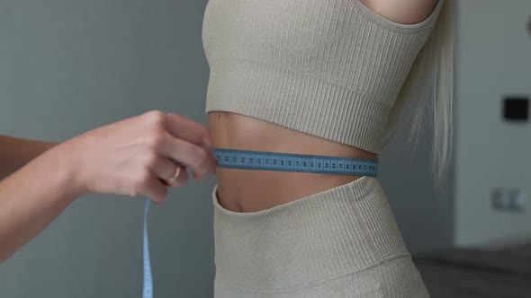 Fit Woman Measuring Waist