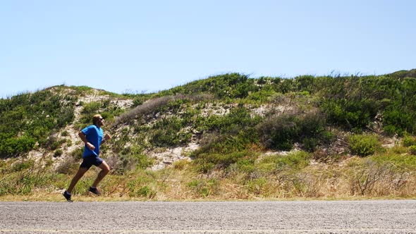 Triathlete man jogging in the countryside road