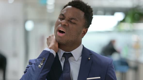 Portrait of African Businessman Having Neck Pain