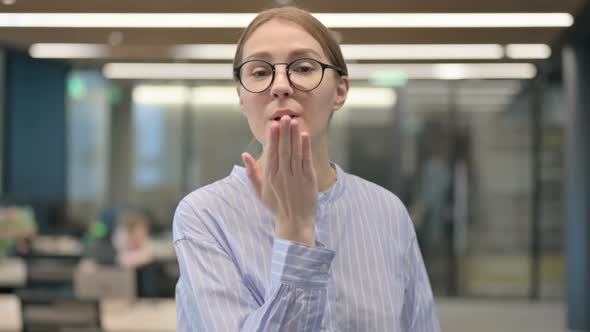 Portrait of Young Woman Giving Flying Kiss