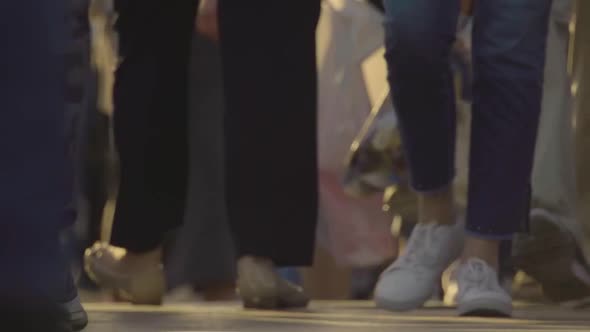 Legs of a crowd walking along Nevsky Prospect on a warm summer Sunday evening