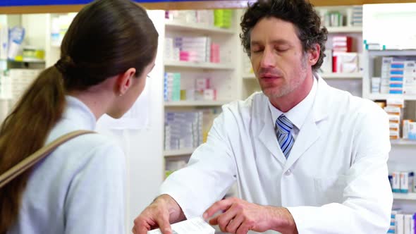 Pharmacist Assisting the Medicine to Customer