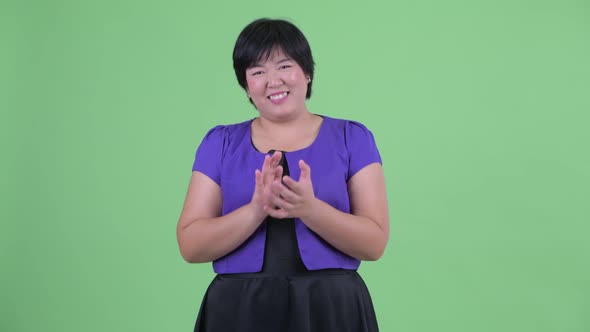 Happy Young Overweight Asian Woman Clapping Hands