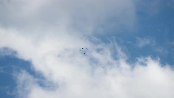 Paragliding against cloudscape