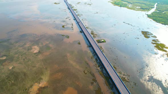 Drone video of the road leads through a large beautiful wetland.