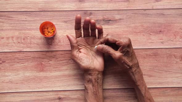 Senior Hand Holding Pills with Copy Space