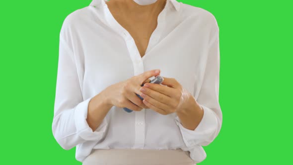 Young Woman Use the Skin Sanitizer To Protect Her Hands From Any Viruses While Walking on a Green