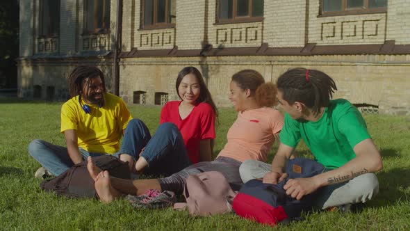 Diverse Multiethnic Students Relaxing at Campus Lawn