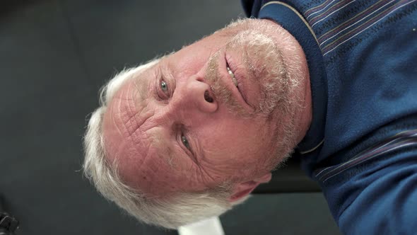 Face of Elderly Man Lifting Weights.