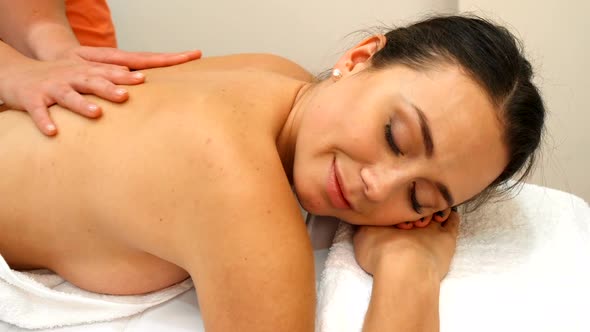 Masseur Massages Woman's Back