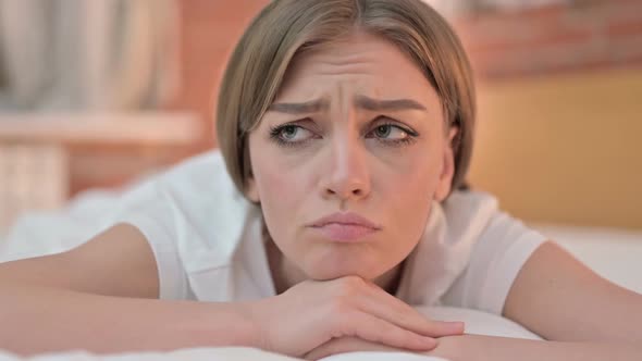 Close Up of Upset Young Woman Feeling Annoyed in Bed