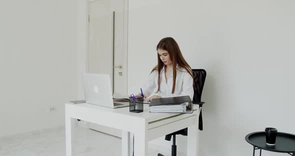 Pretty Student Has Online Lesson on Laptop at Workplace During Remote Learning