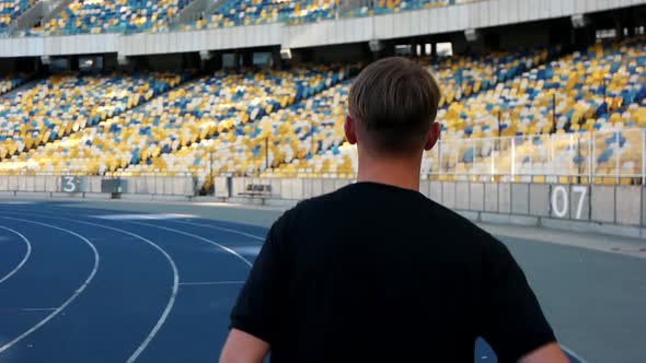 Guy Runs in the Stadium