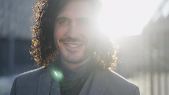 Closeup Portrait of Satisfied Successful Businessman Posing in Sunbeam Outdoors in the Morning