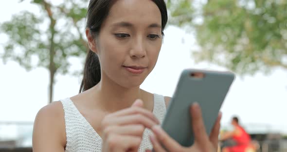 Woman using mobile phone in Hong Kong city